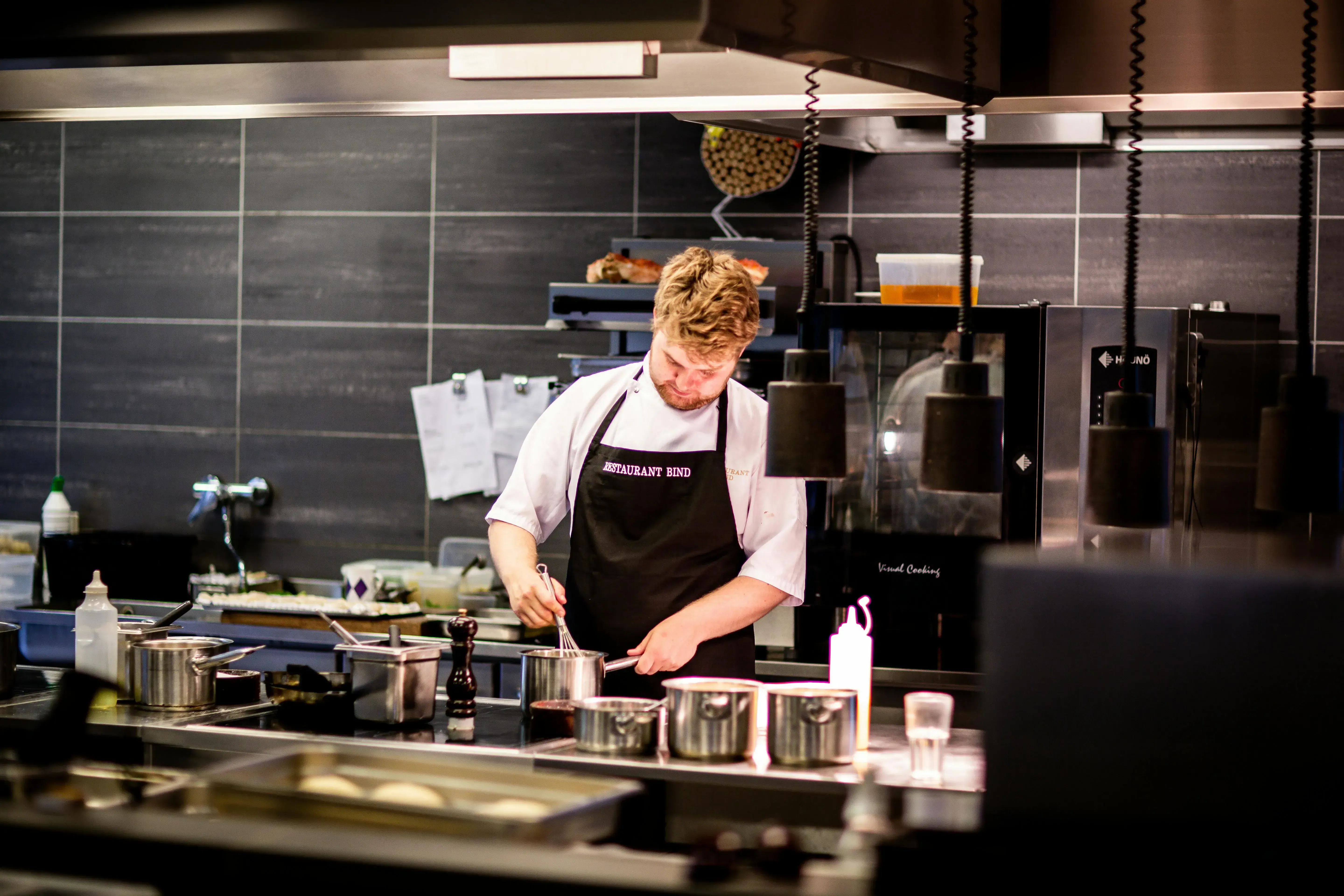 A professional chef preparing a meal in a modern kitchen, showcasing the art of cooking.