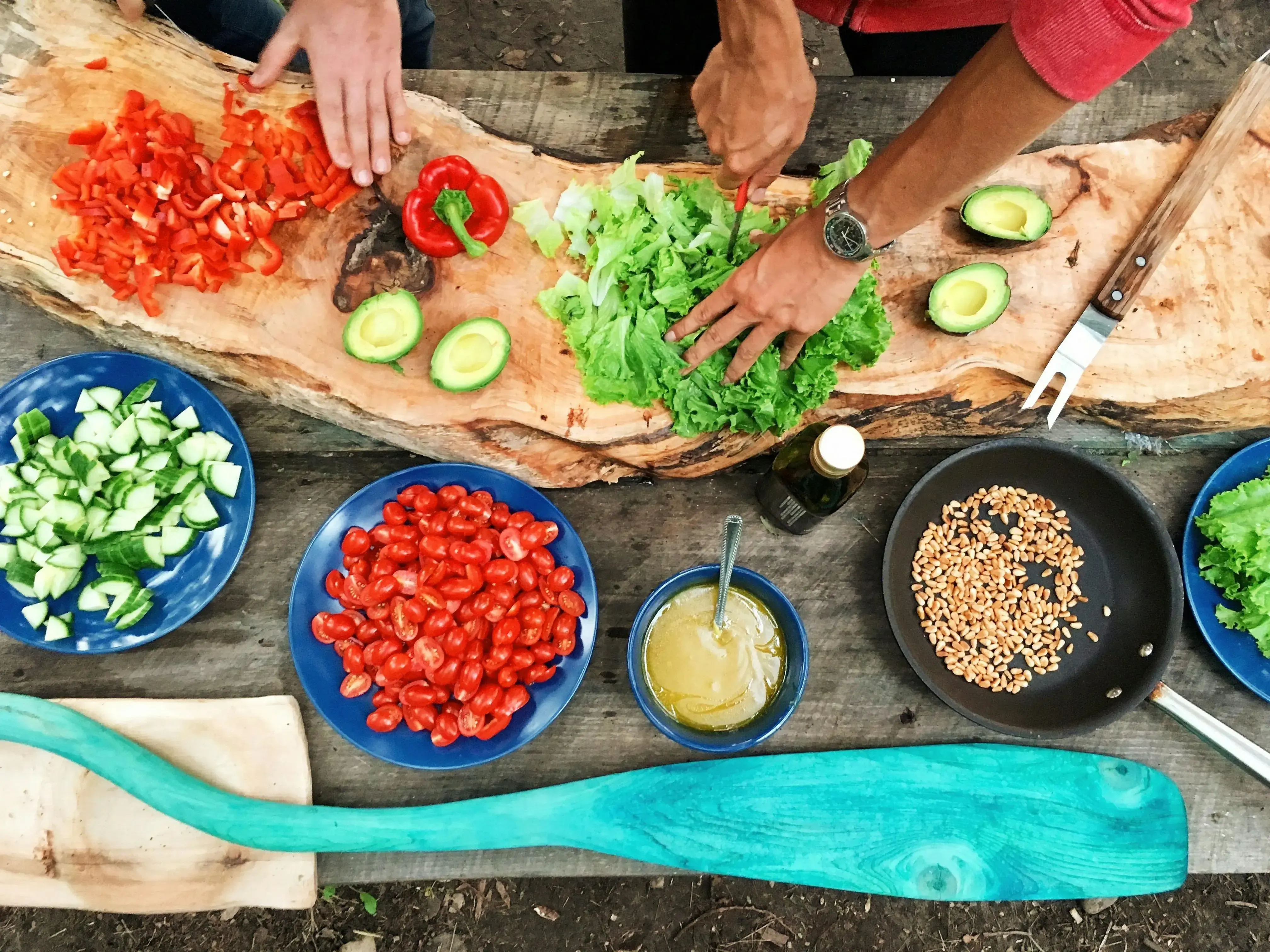 A vibrant kitchen scene with fresh ingredients, a chef preparing a meal, and a variety of colorful dishes on the table.